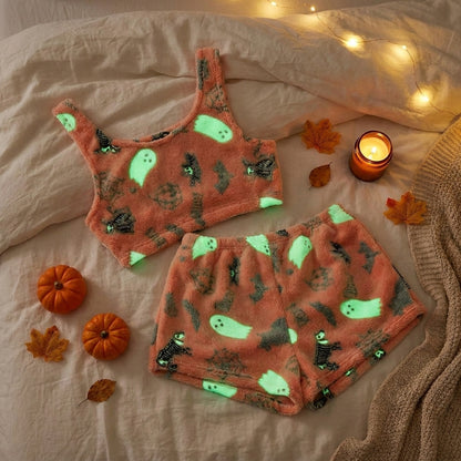 Fleece Halloween pajama set flat lay showing glowing ghosts, bats and spider webs